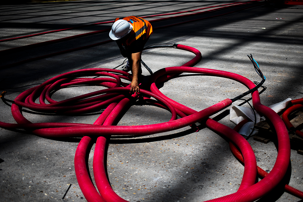 Sol du Grand Palais, avec un artisan et des tuyaux rouges