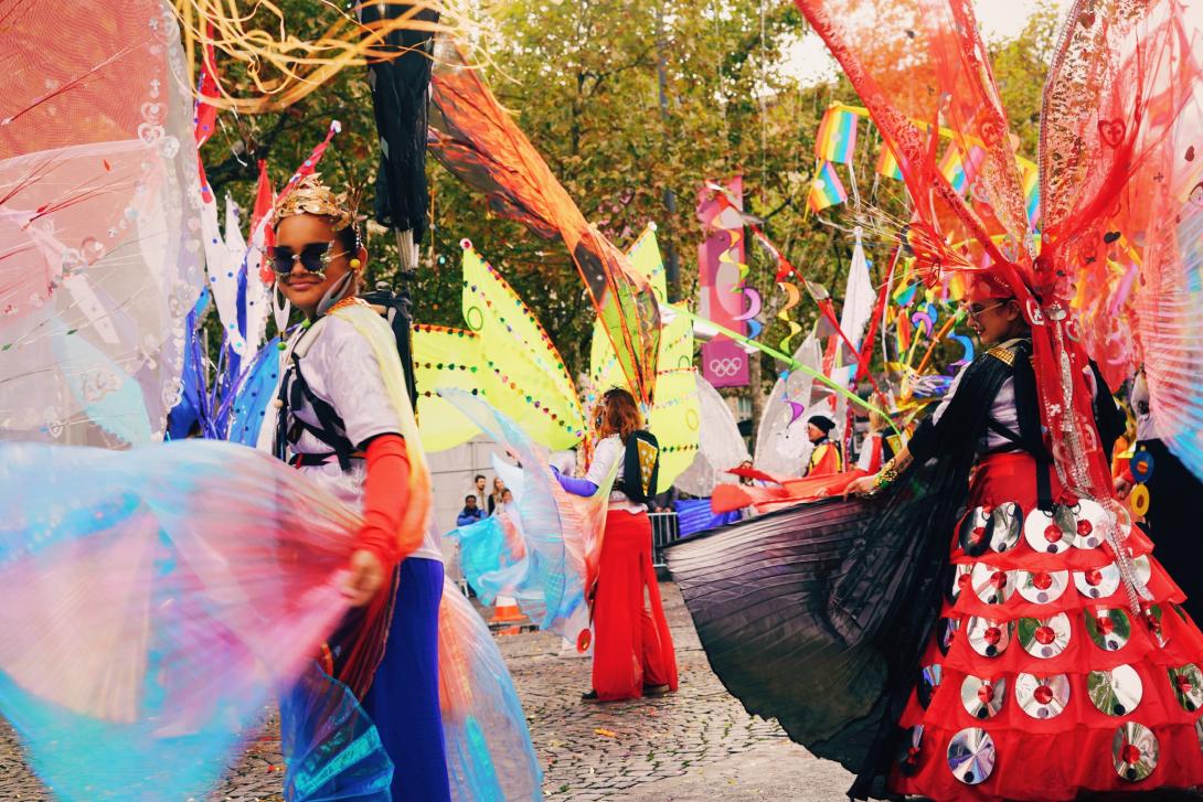 Des personnes en costumes colorés dansant dans la rue